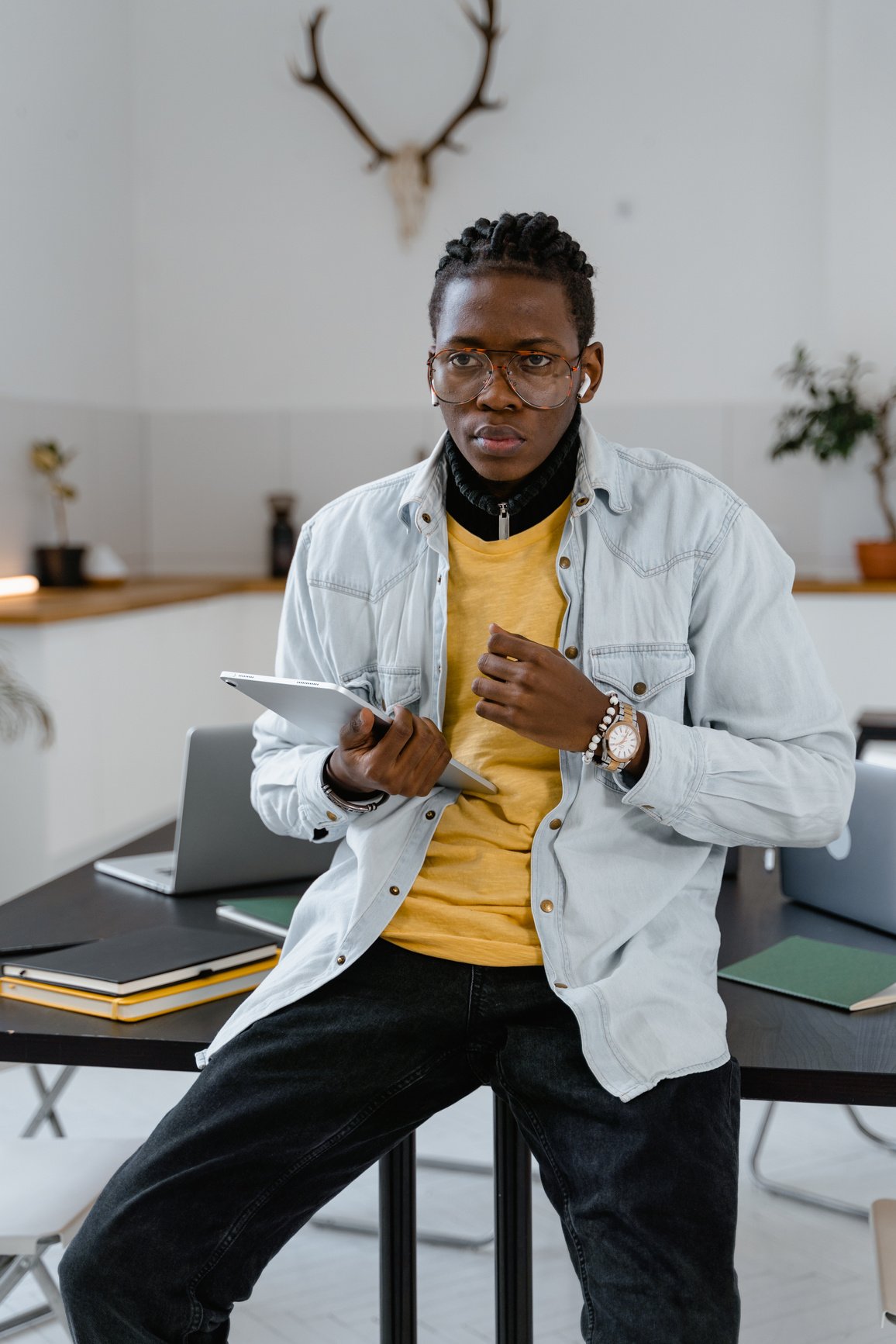 Man With Dreadlocks Holding an Ipad